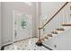 Elegant foyer featuring tile flooring, a staircase, and a stained-glass front door at 579 Delphinium Nw Blvd, Acworth, GA 30102