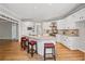 Bright white kitchen with custom cabinets, island and stainless appliances at 579 Delphinium Nw Blvd, Acworth, GA 30102
