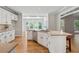 Bright kitchen with stainless steel appliances and granite countertops overlooks an adjacent dining area with lots of natural light at 579 Delphinium Nw Blvd, Acworth, GA 30102