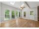 Open concept living area with skylights, hardwood floors, and bright sunny windows leads to an outdoor porch at 579 Delphinium Nw Blvd, Acworth, GA 30102