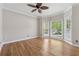 Inviting living room boasting hardwood floors, large windows, and a ceiling fan at 579 Delphinium Nw Blvd, Acworth, GA 30102