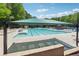 Community pool with plenty of lounge chairs and shade for residents to enjoy on sunny days at 579 Delphinium Nw Blvd, Acworth, GA 30102