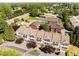 Aerial view of a neighborhood community featuring red and white townhouses with treed landscape at 735 Neel Reid Dr, Roswell, GA 30075