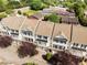 Aerial shot of townhouses featuring well-kept roofs and tree lined streets at 735 Neel Reid Dr, Roswell, GA 30075