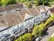 View from above showcases the townhouse roofs, balconies, and tree-lined street at 735 Neel Reid Dr, Roswell, GA 30075