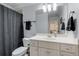 Well-lit bathroom featuring a single vanity and a shower-tub combination at 735 Neel Reid Dr, Roswell, GA 30075