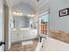 Bright bathroom with double vanity, soaking tub, and a large window with neighborhood views at 735 Neel Reid Dr, Roswell, GA 30075