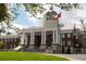 Exterior view of City Hall featuring classical architecture, lawn, and flagpole with the Georgia state flag at 735 Neel Reid Dr, Roswell, GA 30075