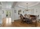 Formal dining room features hardwood floors, chandelier, and access to a bright sunroom at 735 Neel Reid Dr, Roswell, GA 30075