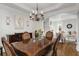Well-lit dining room showcasing hardwood floors, chandelier, and easy access to the living room at 735 Neel Reid Dr, Roswell, GA 30075