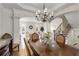 Open-concept dining room with hardwood floors, chandelier, and easy access to the living areas at 735 Neel Reid Dr, Roswell, GA 30075