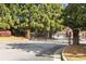 Community entrance gate with mature trees and landscaping welcomes residents to Olde Town Roswell at 735 Neel Reid Dr, Roswell, GA 30075