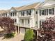 Charming townhome with white siding, black shutters, a garage, and a small front porch at 735 Neel Reid Dr, Roswell, GA 30075