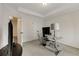 Home office with a glass top desk, closet, and views of the hallway at 735 Neel Reid Dr, Roswell, GA 30075