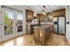This kitchen features granite counters, stainless appliances, wooden cabinets, and hardwood flooring at 735 Neel Reid Dr, Roswell, GA 30075