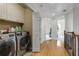A convenient laundry room with washer and dryer, cabinets, and hardwood floors at 735 Neel Reid Dr, Roswell, GA 30075
