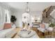 Stylish living room with hardwood floors, a fireplace, and access to the staircase at 735 Neel Reid Dr, Roswell, GA 30075