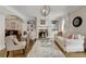 Cozy living room with a white sofa, chairs, a fireplace and built-in shelves at 735 Neel Reid Dr, Roswell, GA 30075
