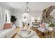 Well-lit living room featuring hardwood floors, stylish furniture, and access to staircase at 735 Neel Reid Dr, Roswell, GA 30075