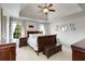 Spacious primary bedroom with hardwood floors, tray ceiling, and lots of natural light at 735 Neel Reid Dr, Roswell, GA 30075