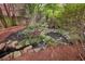 Serene backyard retreat with a small stream, lush greenery, and rock features creating a peaceful oasis at 1153 Brookhaven Commons Ne Dr, Brookhaven, GA 30319
