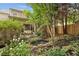 Beautiful backyard with lush greenery, pond, and covered porch, perfect for outdoor relaxation and entertaining at 1153 Brookhaven Commons Ne Dr, Brookhaven, GA 30319