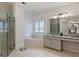 Bathroom featuring glass shower, soaking tub, and vanity with granite countertop at 1153 Brookhaven Commons Ne Dr, Brookhaven, GA 30319