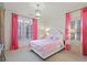 Bright bedroom with pink accents, including pink curtains, pillows, and a pink and white checkered duvet at 1153 Brookhaven Commons Ne Dr, Brookhaven, GA 30319