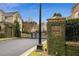Community entrance with gate and ivy covered stone pillar that reads Brookhaven Commons Est. 2000 at 1153 Brookhaven Commons Ne Dr, Brookhaven, GA 30319