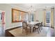 Elegant dining room featuring a decorative chandelier, neutral tones, and backyard views, perfect for entertaining at 1153 Brookhaven Commons Ne Dr, Brookhaven, GA 30319