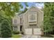 Charming two-story home with a well-maintained lawn, attached two car garage and beautiful mature trees at 1153 Brookhaven Commons Ne Dr, Brookhaven, GA 30319