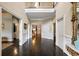 Grand foyer showcasing dark hardwood floors, detailed trim, and a view to the second story landing at 1153 Brookhaven Commons Ne Dr, Brookhaven, GA 30319