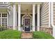 Elegant home exterior showcasing a covered front entrance with stone accents and manicured landscaping at 1153 Brookhaven Commons Ne Dr, Brookhaven, GA 30319