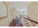 Upstairs hallway with beautiful artwork, a staircase, and natural light, creating a bright and airy space at 1153 Brookhaven Commons Ne Dr, Brookhaven, GA 30319