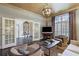 Bright living room with natural light, stylish furniture, and double doors leading to another room at 1153 Brookhaven Commons Ne Dr, Brookhaven, GA 30319