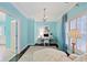 Home office boasts light blue walls, a chandelier, and a bright sunny window at 1153 Brookhaven Commons Ne Dr, Brookhaven, GA 30319