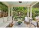 Covered patio featuring stone floor, comfortable seating, and a view of the lush garden at 1153 Brookhaven Commons Ne Dr, Brookhaven, GA 30319