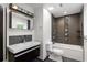 Modern bathroom featuring stylish mirror, mosaic tiles, and tub with shower at 1261 Lavista Rd # C3, Atlanta, GA 30324