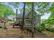 Landscaped backyard featuring a deck, screened-in porch, and stairs leading to the upper yard at 1988 Claiborne Ct, Marietta, GA 30062