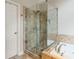Elegant bathroom featuring a tiled glass shower and a luxurious soaking tub with modern fixtures at 1988 Claiborne Ct, Marietta, GA 30062