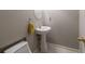 Powder room with pedestal sink, white toilet, and silver hardware at 1988 Claiborne Ct, Marietta, GA 30062