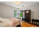 Cozy bedroom with natural light, hardwood floors and a quaint armoire at 1988 Claiborne Ct, Marietta, GA 30062