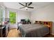 Spacious bedroom with wood floors, desk area, and a bright window overlooking trees at 1988 Claiborne Ct, Marietta, GA 30062