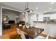 Open concept dining area featuring a wooden table, white chairs, and hardwood floors at 1988 Claiborne Ct, Marietta, GA 30062