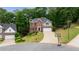 Two-story brick home boasting manicured landscaping, a two-car garage, and a basketball hoop at 1988 Claiborne Ct, Marietta, GA 30062