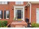 Elegant brick entryway with a black front door and decorative columns at 1988 Claiborne Ct, Marietta, GA 30062
