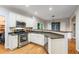 Modern kitchen with stainless steel appliances, granite countertops, and white cabinets at 1988 Claiborne Ct, Marietta, GA 30062