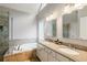 Main bathroom featuring a soaking tub, dual vanities, and a glass-enclosed shower at 1988 Claiborne Ct, Marietta, GA 30062