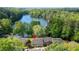 Aerial shot of a brick home near a lake, surrounded by lush trees and greenery at 2495 Northlake Ne Ct, Atlanta, GA 30345
