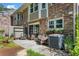 Outdoor patio seating area with brick exterior, flowers and lush landscaping at 2495 Northlake Ne Ct, Atlanta, GA 30345